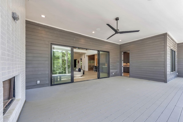 wooden terrace featuring a ceiling fan