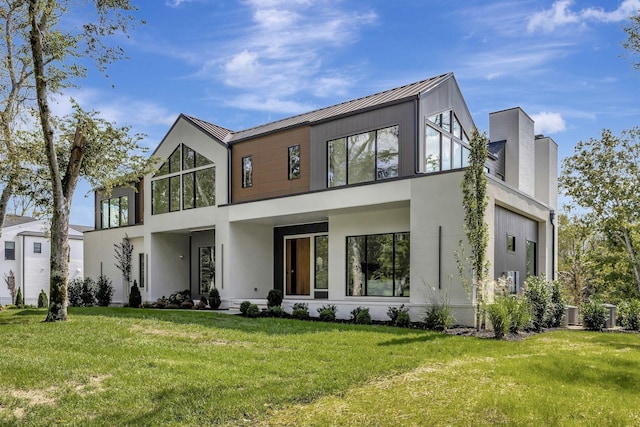 contemporary house with a standing seam roof, metal roof, and a front yard