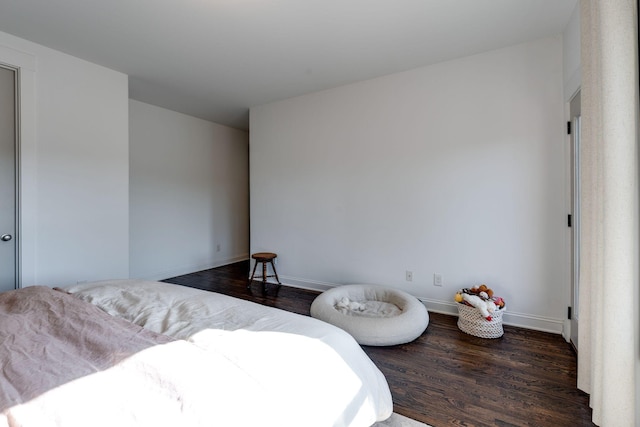 bedroom featuring baseboards and wood finished floors