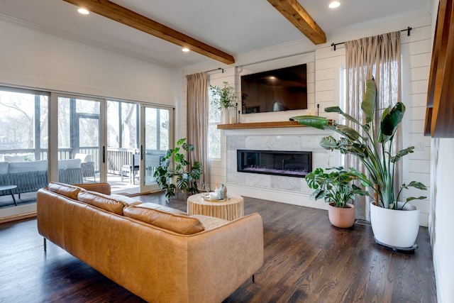 living room featuring beam ceiling, wood finished floors, and a high end fireplace