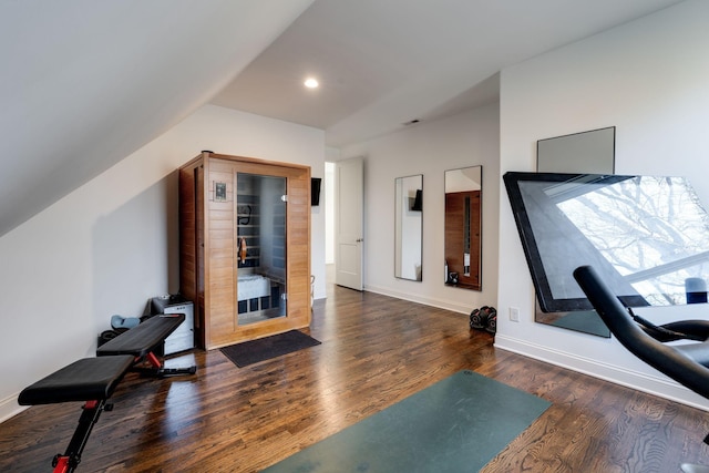 exercise room with recessed lighting, baseboards, wood finished floors, and vaulted ceiling