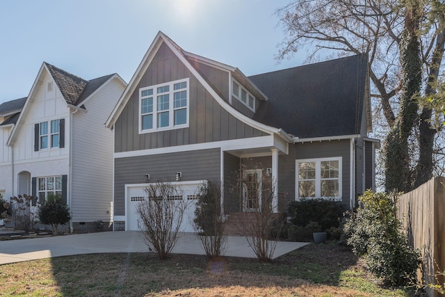 view of front of property with driveway, fence, board and batten siding, an attached garage, and crawl space