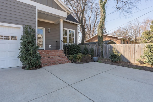 exterior space featuring a garage and fence