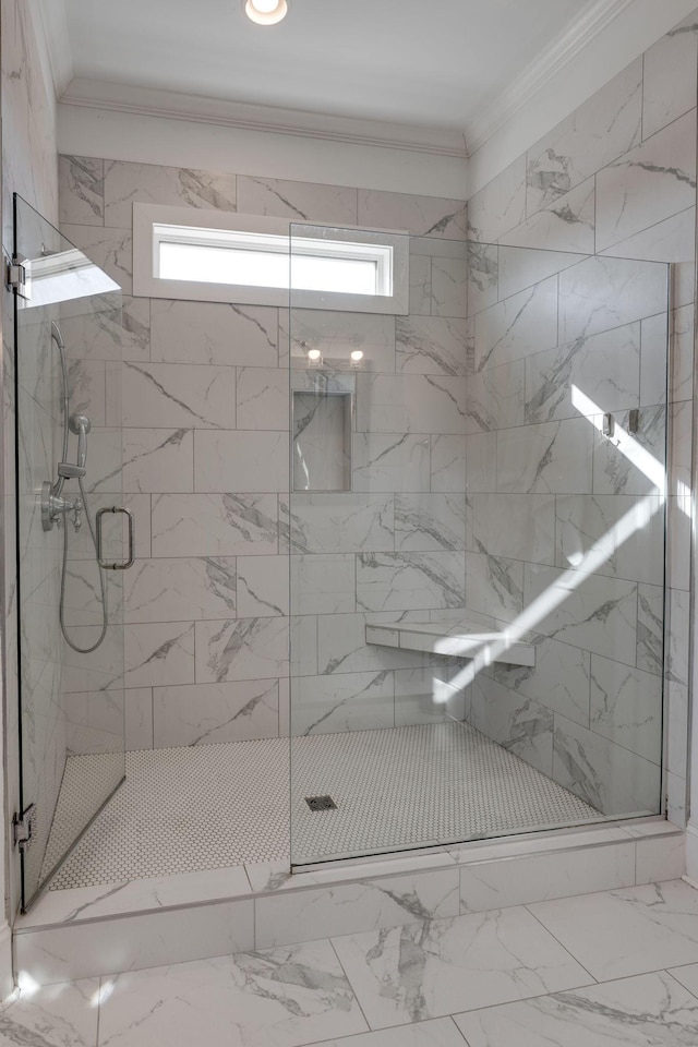 full bath featuring marble finish floor, a marble finish shower, and ornamental molding