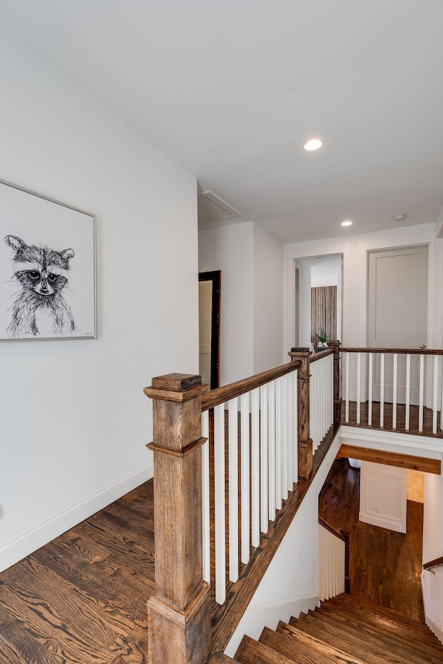 stairway with recessed lighting, baseboards, and wood finished floors