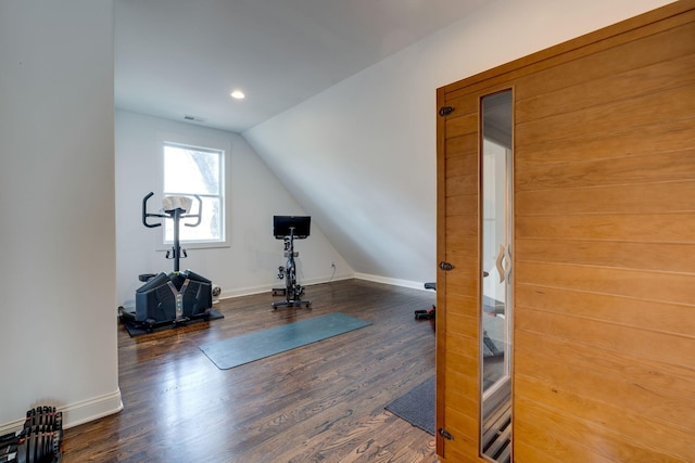 workout room featuring wood finished floors, visible vents, baseboards, recessed lighting, and vaulted ceiling