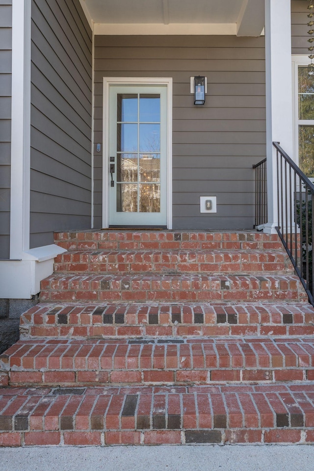 view of exterior entry with brick siding