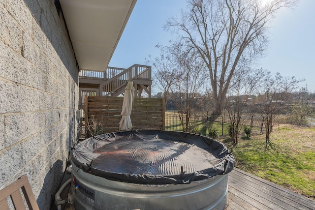 deck with stairs and fence