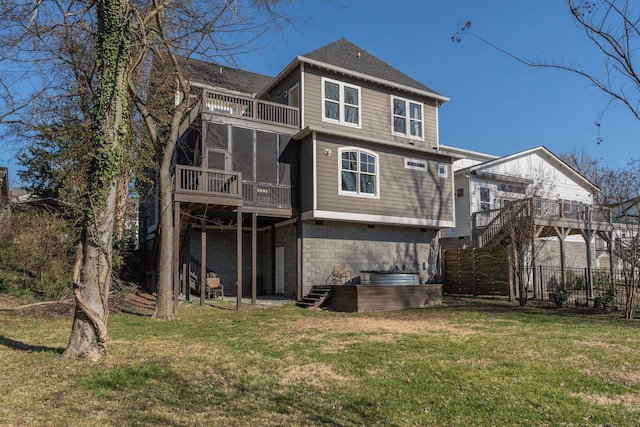 back of house with fence, a lawn, stairs, and a sunroom