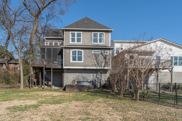 rear view of house featuring stairway, fence, a lawn, and a sunroom