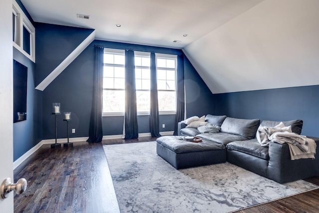 living area with dark wood-type flooring, visible vents, baseboards, and lofted ceiling