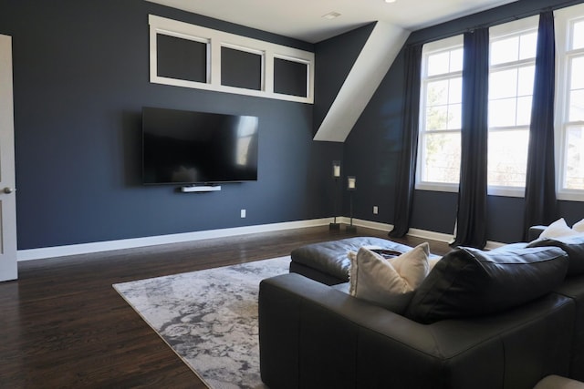 living area featuring baseboards and wood finished floors