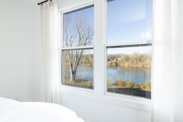 unfurnished bedroom featuring a water view