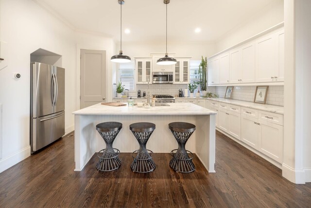 kitchen featuring decorative backsplash, appliances with stainless steel finishes, dark wood finished floors, and white cabinetry