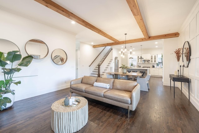 living area with beamed ceiling, stairway, an inviting chandelier, baseboards, and dark wood-style flooring