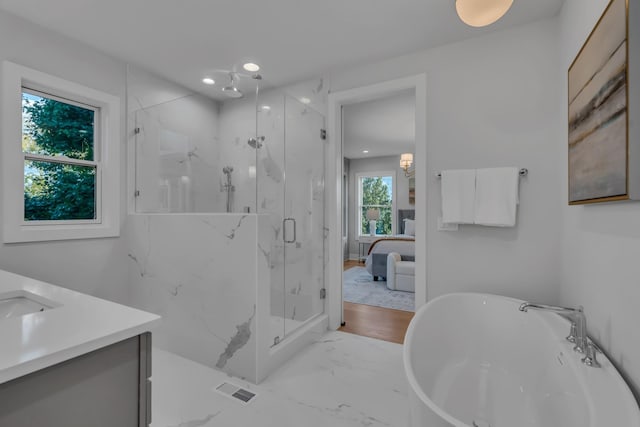 bathroom featuring recessed lighting, vanity, marble finish floor, a soaking tub, and a marble finish shower