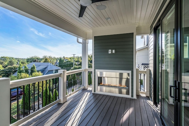 wooden deck with a ceiling fan