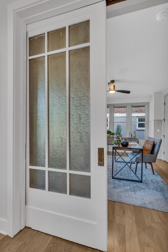 doorway to outside with ceiling fan and wood finished floors