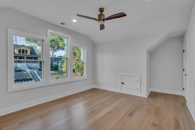 bonus room featuring baseboards, vaulted ceiling, visible vents, and light wood finished floors