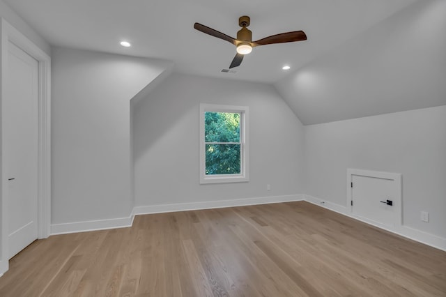 additional living space featuring light wood finished floors, baseboards, vaulted ceiling, and recessed lighting