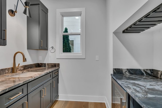 interior space featuring wood finished floors, vanity, and baseboards