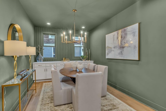 dining space with a chandelier, recessed lighting, light wood-style flooring, and baseboards