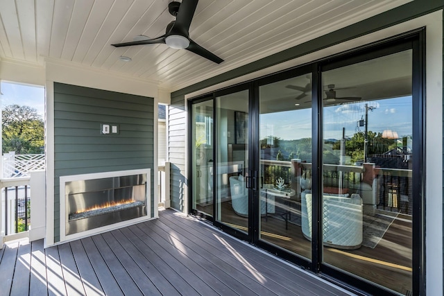 wooden terrace with a ceiling fan