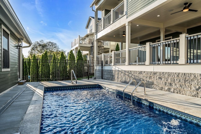 view of pool featuring a fenced in pool, fence, a ceiling fan, and a patio