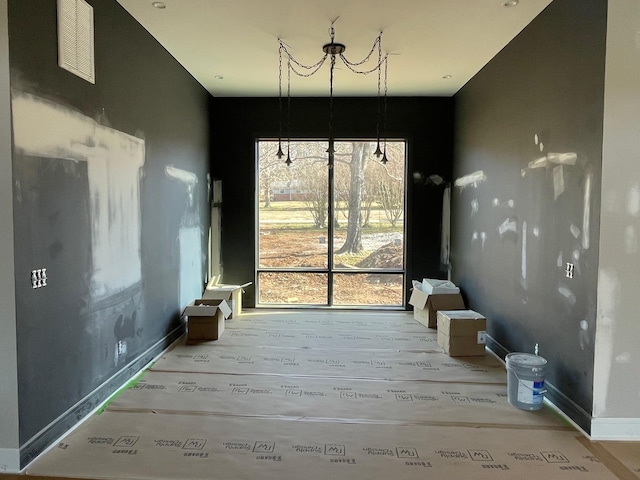 interior space featuring baseboards, visible vents, and wood finished floors