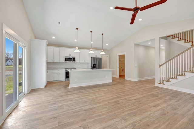 kitchen featuring stainless steel appliances, a wealth of natural light, and light wood finished floors