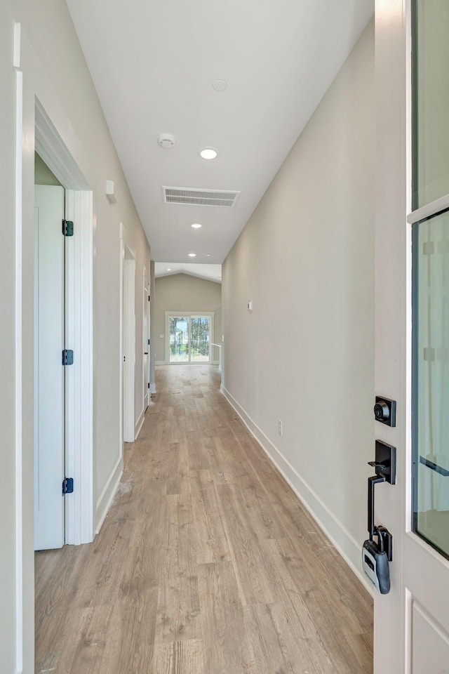 hall with recessed lighting, visible vents, baseboards, vaulted ceiling, and light wood finished floors