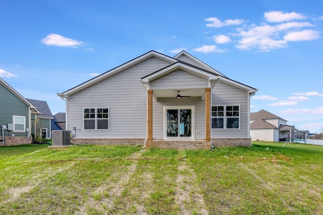 back of house with a ceiling fan, central AC, and a lawn