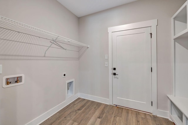 laundry room featuring laundry area, baseboards, wood finished floors, hookup for an electric dryer, and washer hookup