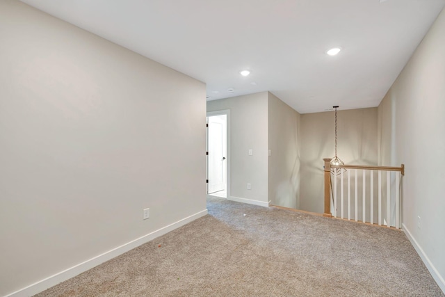 carpeted empty room featuring baseboards and recessed lighting