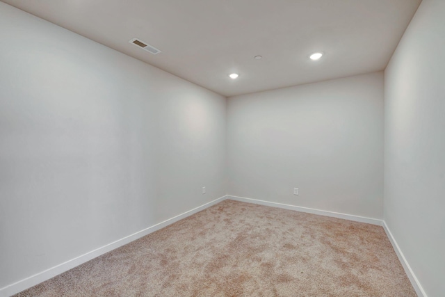 carpeted spare room with recessed lighting, visible vents, and baseboards