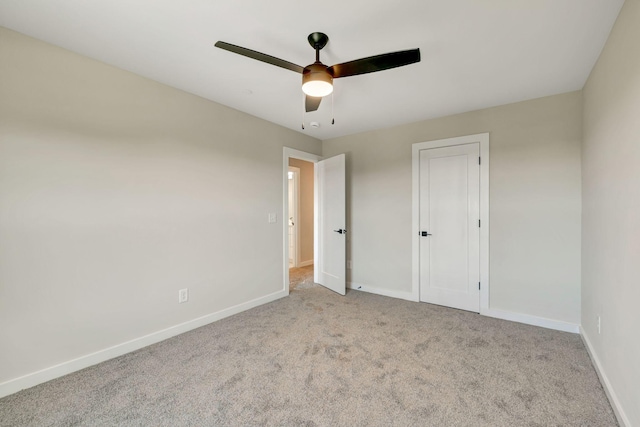 unfurnished bedroom featuring ceiling fan, baseboards, and carpet flooring