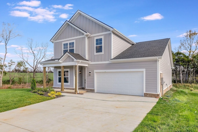 view of front facade with a shingled roof, concrete driveway, a porch, board and batten siding, and a front yard