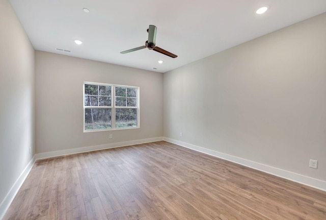 unfurnished room with light wood-style floors, recessed lighting, visible vents, and baseboards