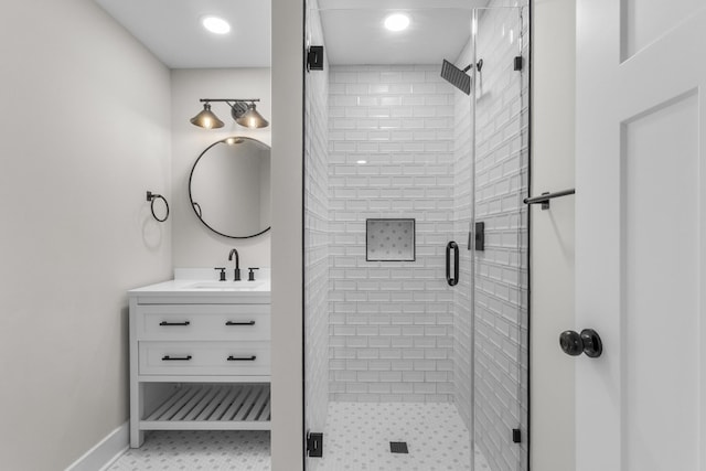 full bath featuring baseboards, a shower stall, and vanity