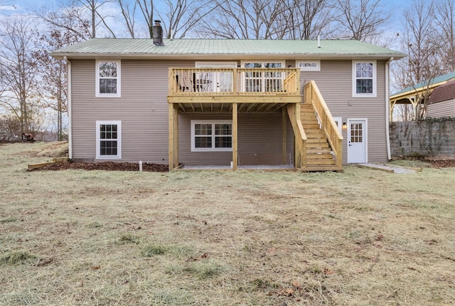 back of property featuring metal roof, a chimney, a wooden deck, and stairs