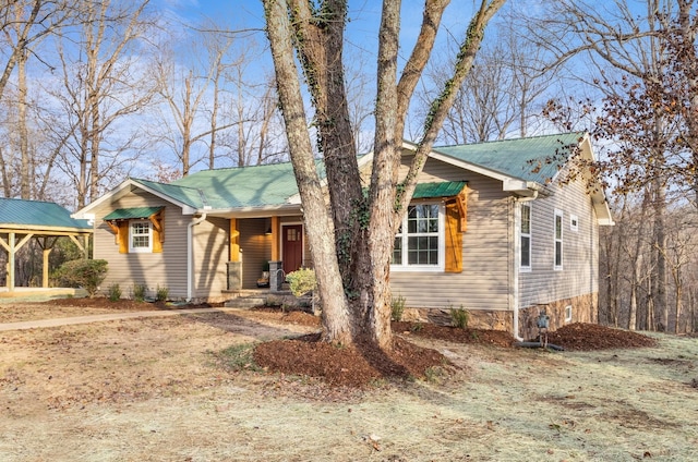 view of front of home with a porch and metal roof