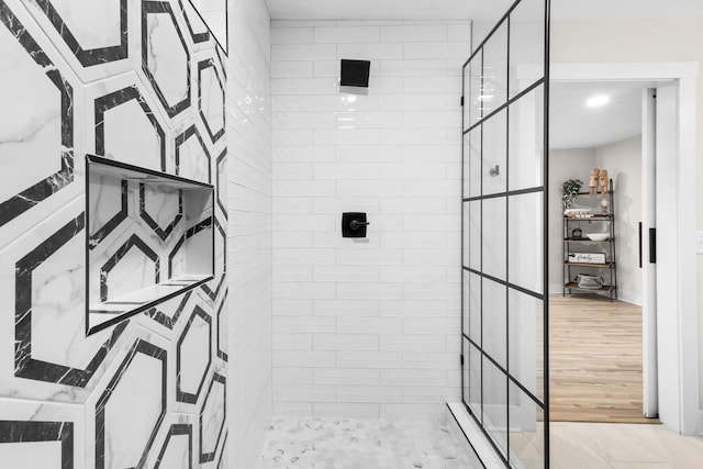 full bathroom featuring a stall shower and wood finished floors