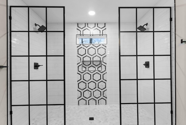 interior details featuring a tile shower