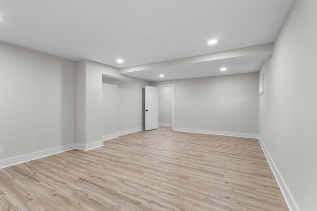 unfurnished room featuring light wood-type flooring, baseboards, and recessed lighting