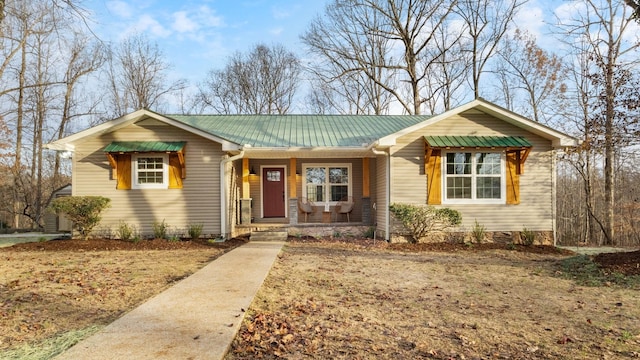 single story home with covered porch and metal roof