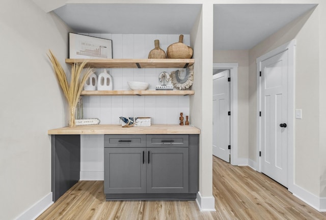 bar with baseboards and light wood-style floors