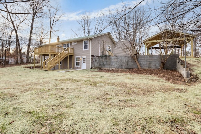 rear view of house featuring a deck, a chimney, and stairway