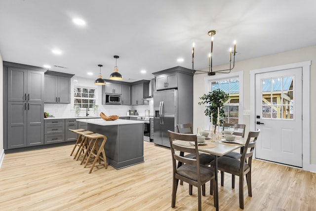 dining room with recessed lighting and light wood-style floors