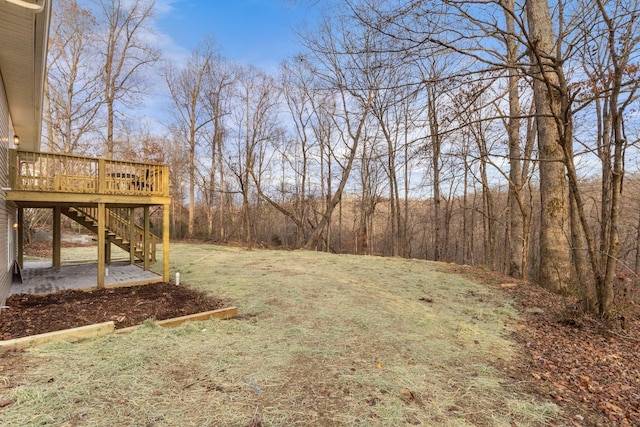 view of yard featuring a deck and stairs