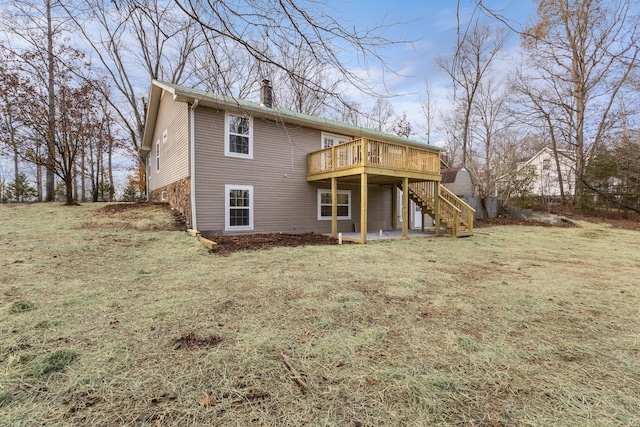 back of property with a chimney, a yard, stairway, and a wooden deck